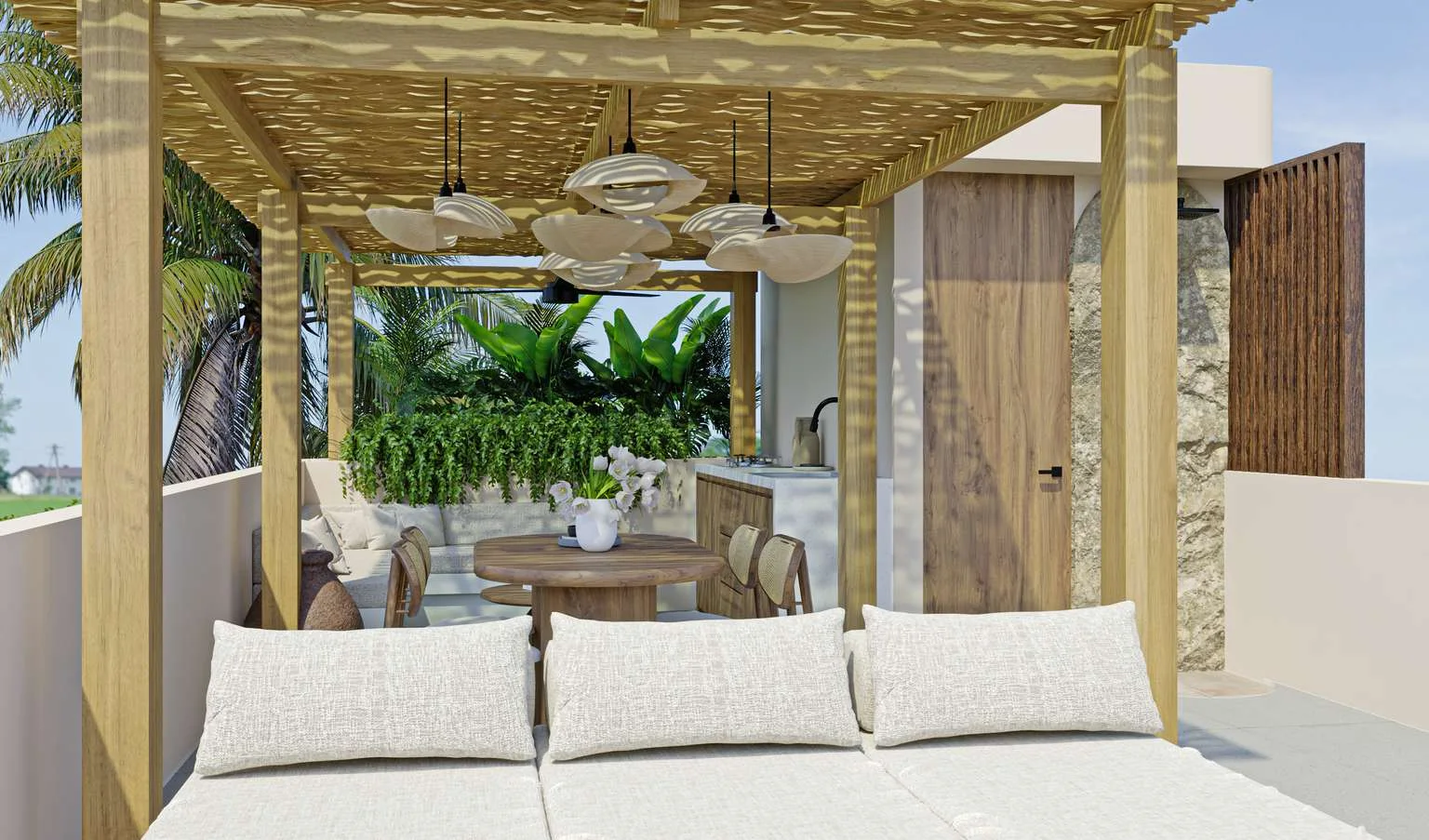 A rooftop lounge under a timber pergola: linen sofas, a low round table, ferns and jungle beyond.